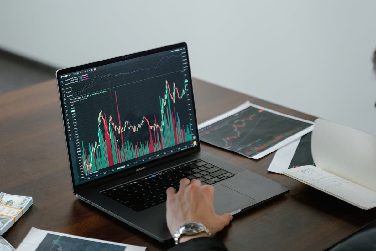 Laptop displaying data analytics charts and graphs on a professional desk