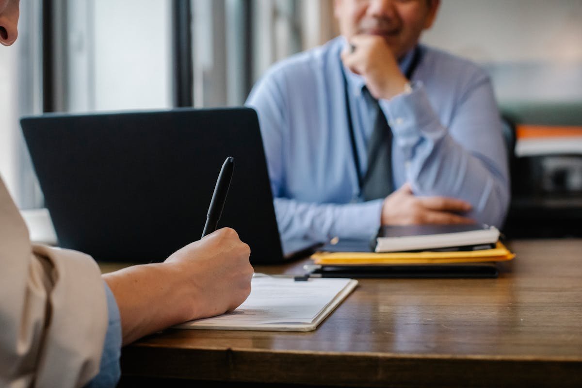 Professional reviewing assessment findings at a desk meeting